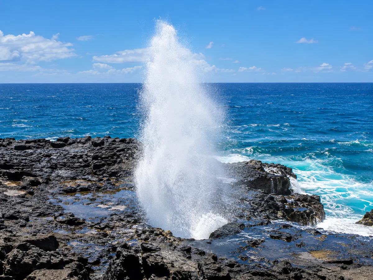 Agua de mar saliendo del Halona Blowhole sobre una plataforma de lava negra, Oahu